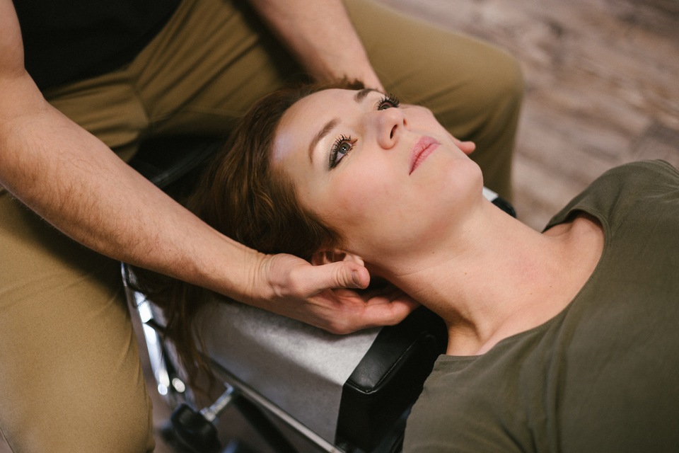 Physiotherapist giving patient a neck massage
