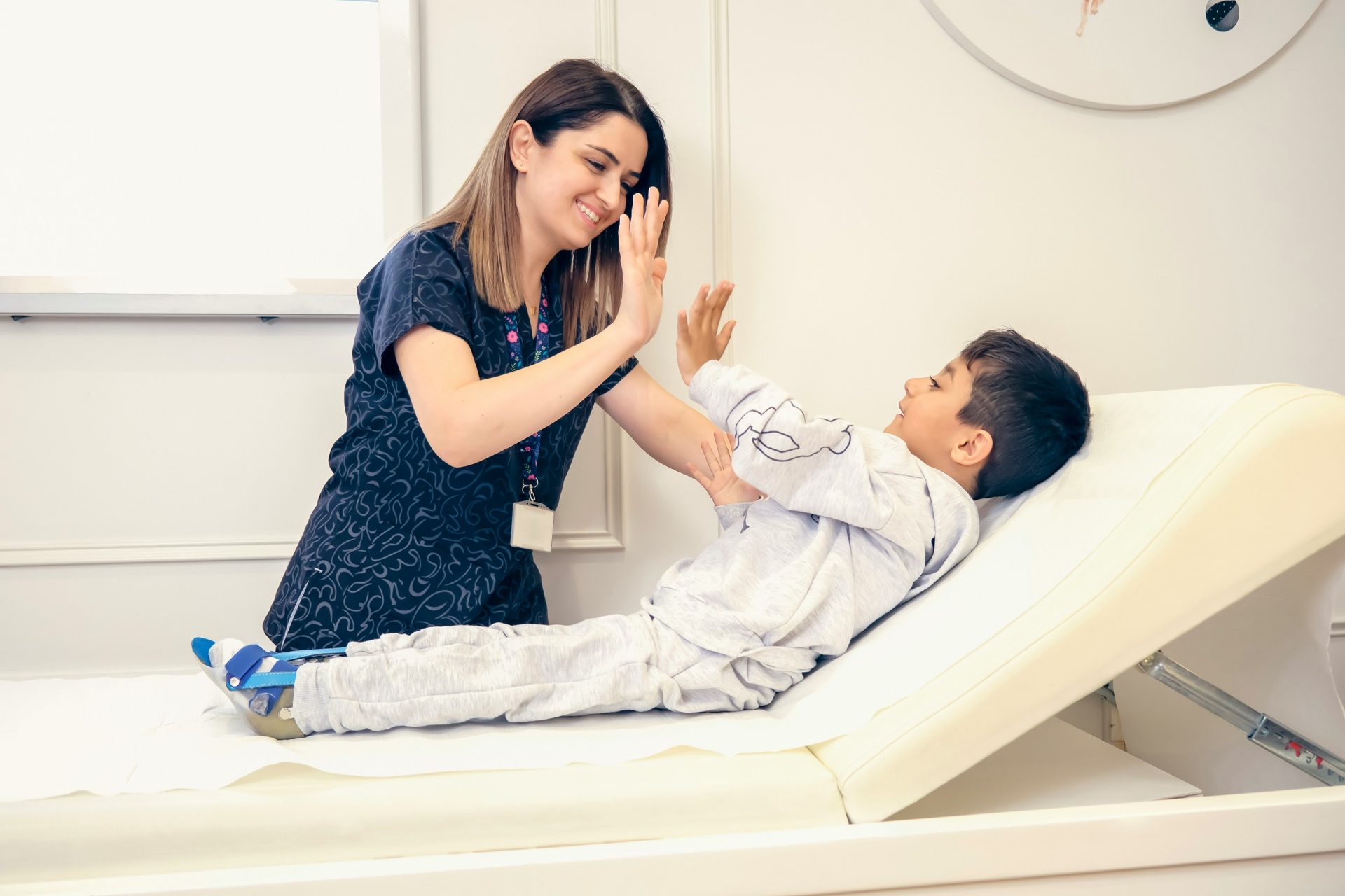 a woman is giving a boy a high five